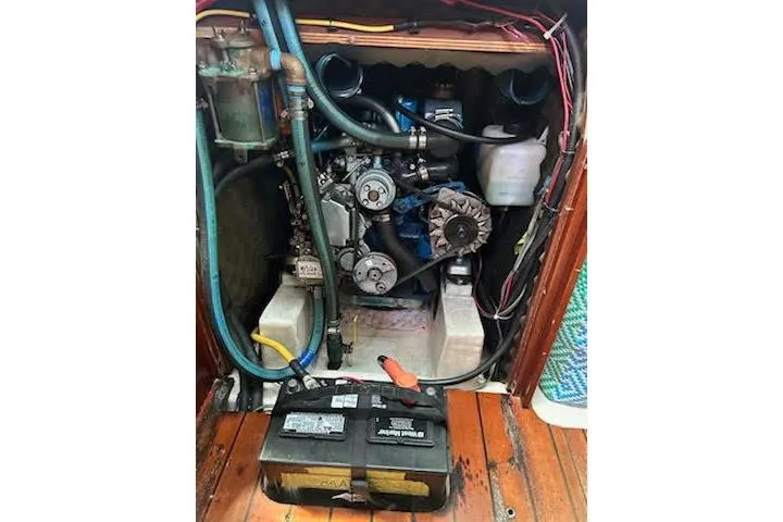 Slide: The Image of Engine compartment of a 1994 Beneteau Oceanis 351 sailboat, showing mechanical components and battery. - 32