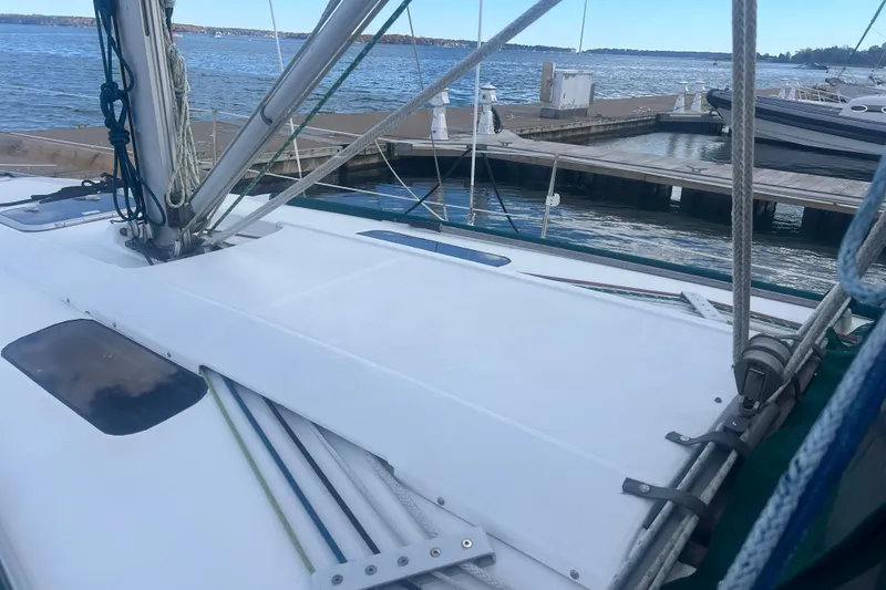 Slide: The Image of 1994 Beneteau Oceanis 351 sailboat docked at marina, showcasing deck and rigging. - 4