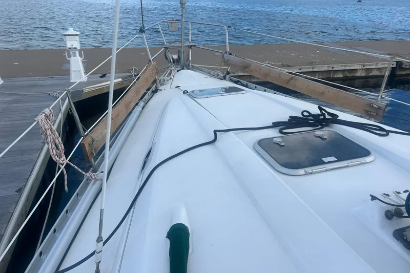 Slide: The Image of 1994 Beneteau Oceanis 351 sailboat docked, showcasing deck and hatch details. - 5