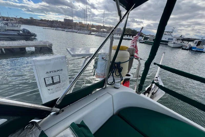 Slide: The Image of Beneteau Oceanis 351 sailboat docked at marina, featuring lifesaving equipment, 1994 model. - 8