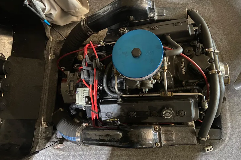 Slide: The Image of 1998 Malibu Sportster engine with blue air filter and red wiring. - 7