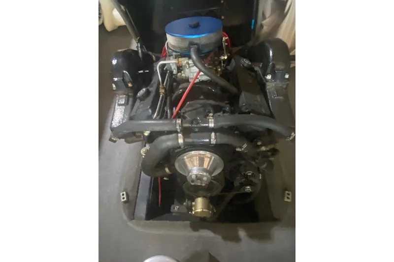 Slide: The Image of 1998 Malibu Sportster engine with blue air filter and red wiring. - 8