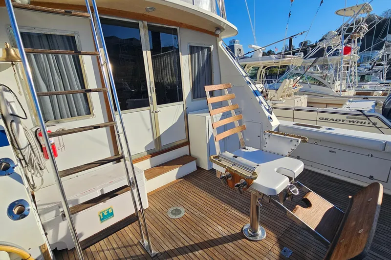 Slide: The Image of 1980 Bertram 42 Convertible yacht deck with fishing chair and ladder. - 15