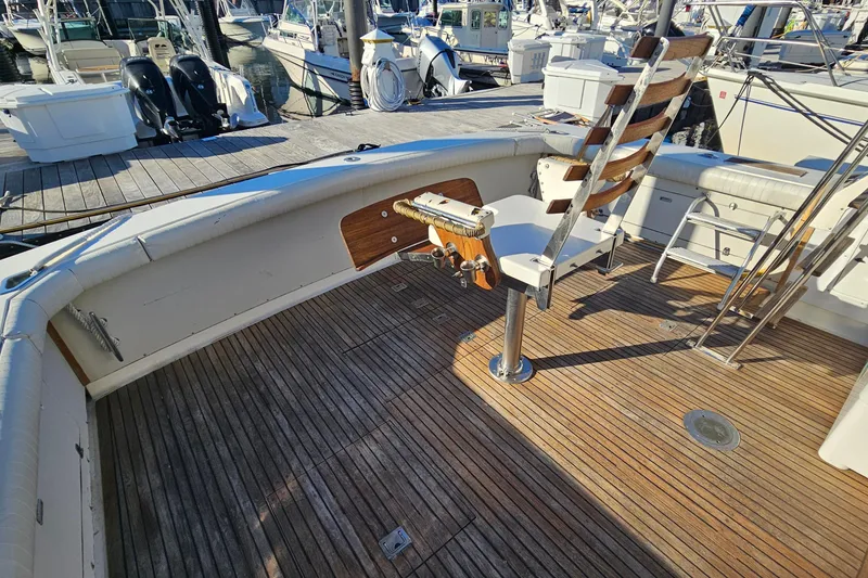 Slide: The Image of 1980 Bertram 42 Convertible boat deck with fishing chair and wooden flooring. - 16