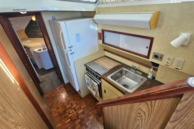 Slide: The Image of 1980 Bertram 42 Convertible yacht interior with kitchen and cabin view. - 23