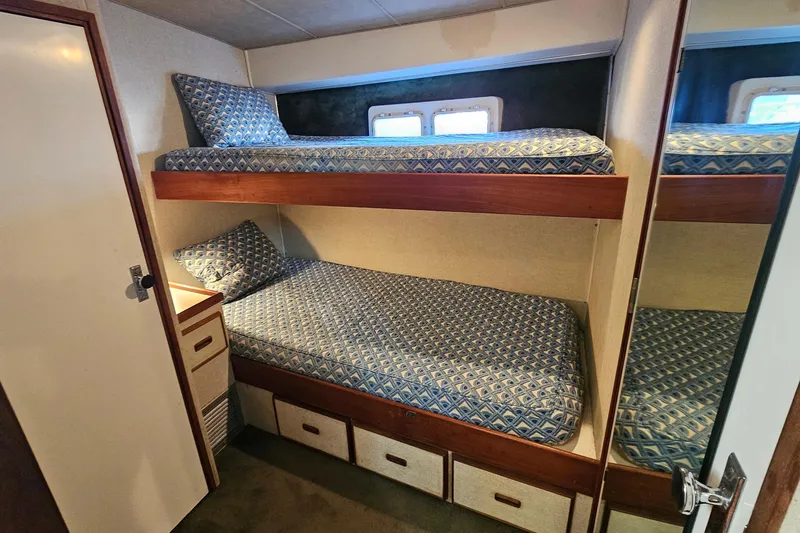 Slide: The Image of Bunk beds in 1980 Bertram 42 Convertible yacht cabin with patterned bedding. - 27