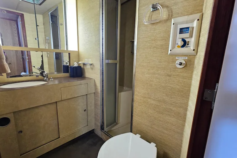 Slide: The Image of Bathroom interior of 1980 Bertram 42 Convertible yacht with sink, mirror, and shower. - 28
