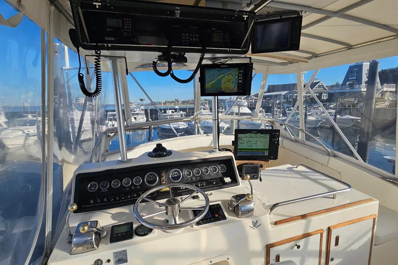 Slide: The Image of Cockpit view of a 1980 Bertram 42 Convertible yacht at a marina. - 29