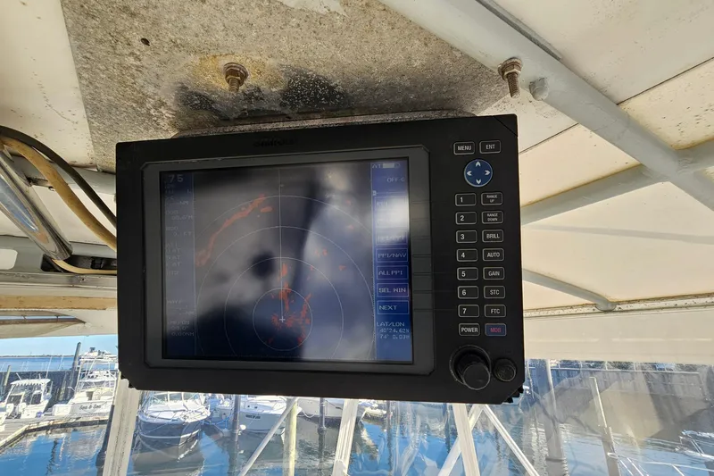 Slide: The Image of Radar display on a 1980 Bertram 42 Convertible boat, docked at a marina. - 38