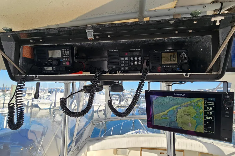 Slide: The Image of Control panel of a 1980 Bertram 42 Convertible with navigation and communication equipment. - 42