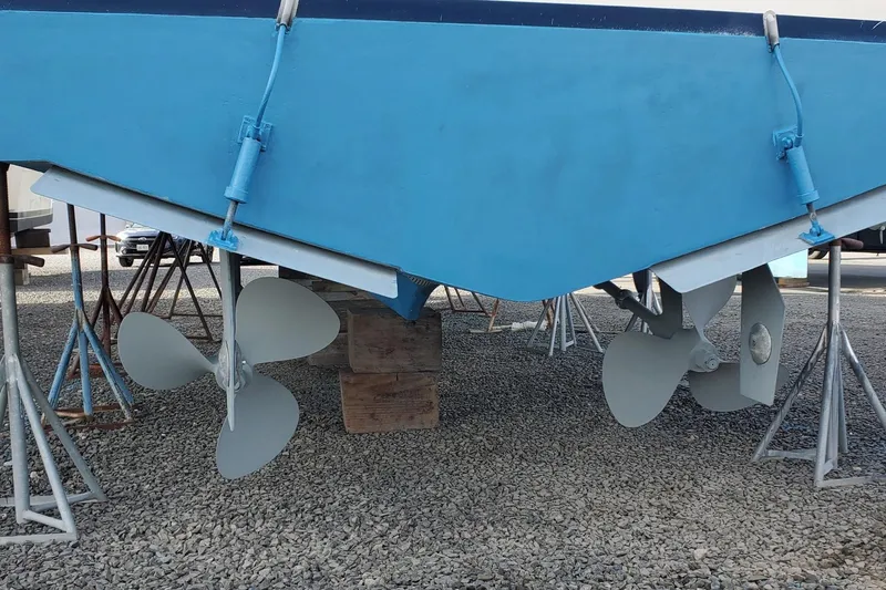 Slide: The Image of 1980 Bertram 42 Convertible boat hull and propellers on dry dock. - 49