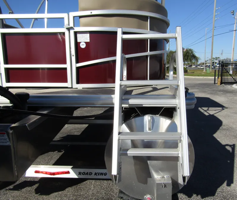 Slide: The Image of 2024 Starcraft LX 20 R pontoon boat with aluminum ladder and maroon paneling. - 4