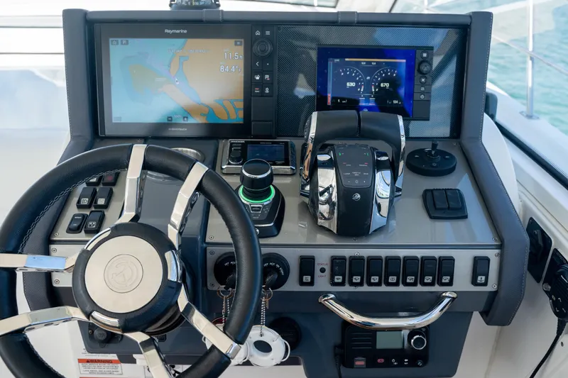 Slide: The Image of Control panel of 2018 Cruisers Yachts 390 Express Coupe with joystick and throttle controls. - 18