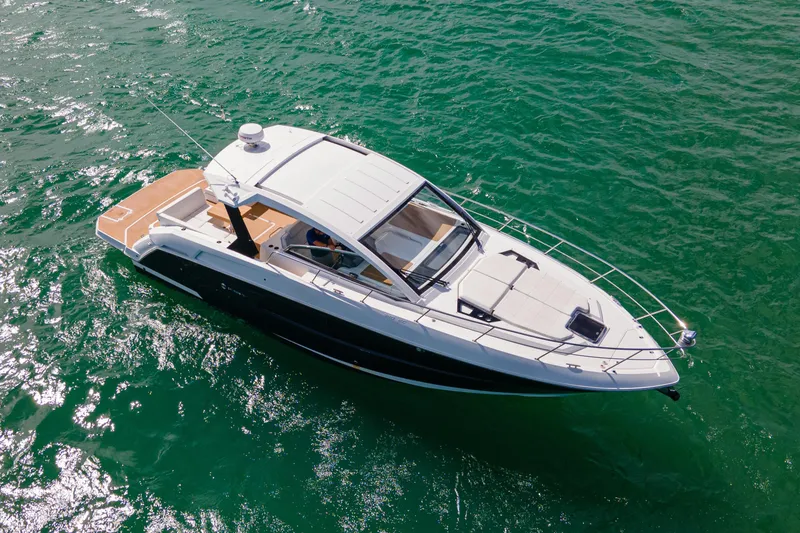 Slide: The Image of 2018 Cruisers Yachts 390 Express Coupe on clear blue water under a sunny sky. - 2