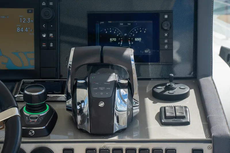 Slide: The Image of 2018 Cruisers Yachts 390 Express Coupe deck with seating and table, overlooking water. - 27