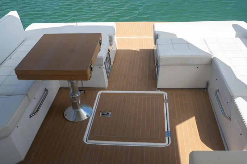 Slide: The Image of 2018 Cruisers Yachts 390 Express Coupe interior seating with white upholstery and cup holder. - 28