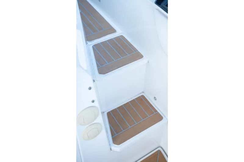 Slide: The Image of 2018 Cruisers Yachts 390 Express Coupe deck view with railing and water backdrop. - 35