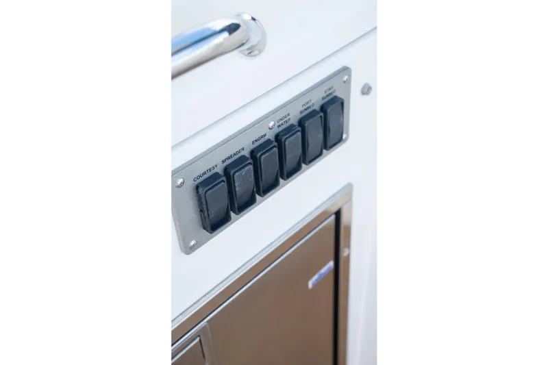 Slide: The Image of Control panel on 2018 Cruisers Yachts 390 Express Coupe with labeled switches. - 38