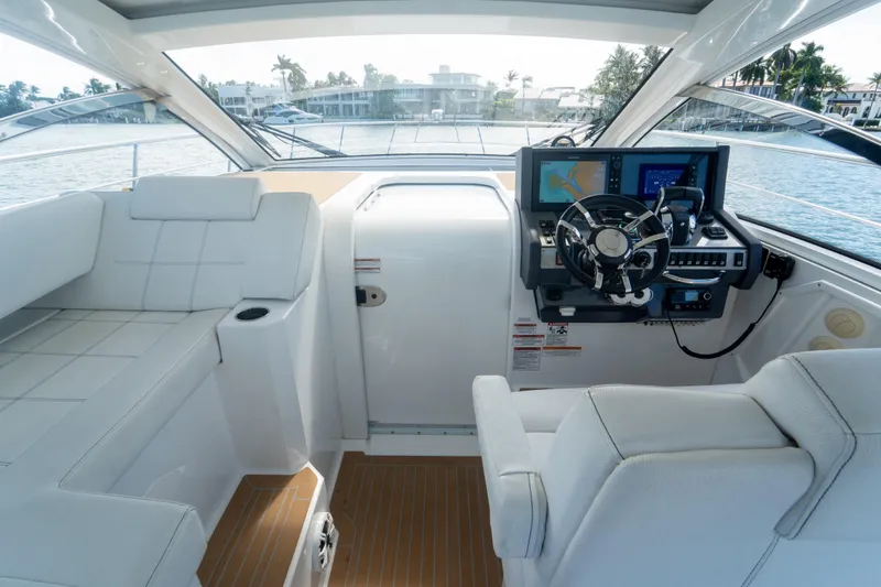 Slide: The Image of 2018 Cruisers Yachts 390 Express Coupe on water, rear view, "Here Be Dragons" text. - 50