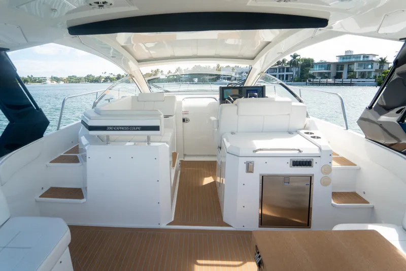 Slide: The Image of 2018 Cruisers Yachts 390 Express Coupe with spacious deck seating and table, overlooking water. - 53