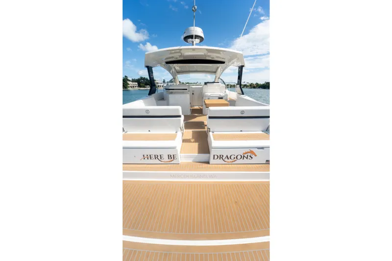 Slide: The Image of 2018 Cruisers Yachts 390 Express Coupe on water, featuring spacious deck seating. - 55