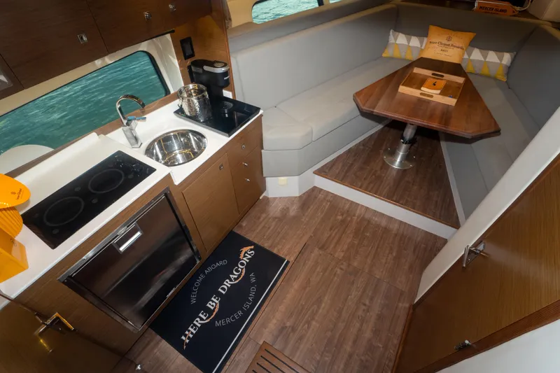 Slide: The Image of 2018 Cruisers Yachts 390 Express Coupe interior with elegant dining area and wooden finishes. - 59