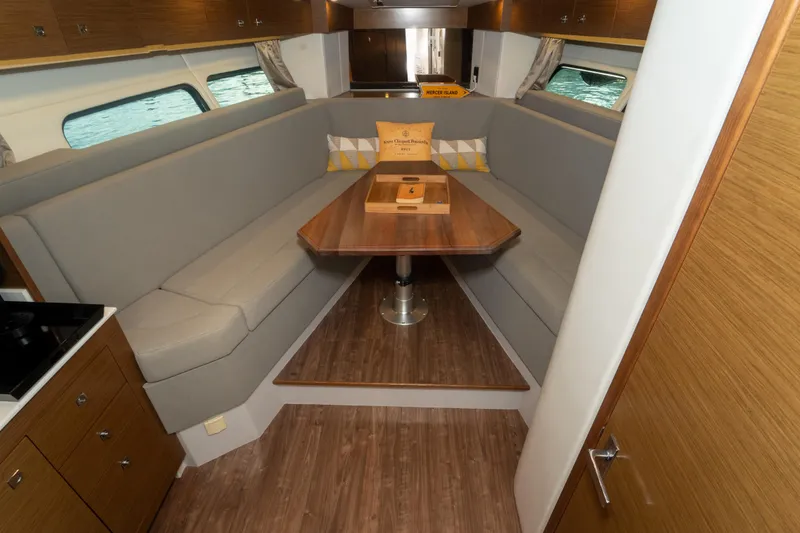 Slide: The Image of 2018 Cruisers Yachts 390 Express Coupe cabin with bed, window, and modern decor. - 60