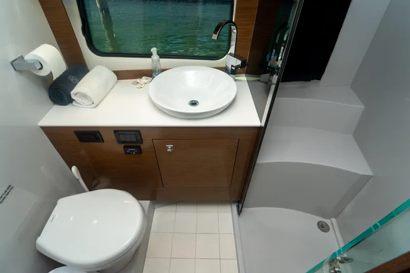 Slide: The Image of Luxurious bathroom in 2018 Cruisers Yachts 390 Express Coupe with modern fixtures and shower. - 62