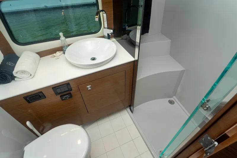 Slide: The Image of 2018 Cruisers Yachts 390 Express Coupe interior with modern seating and wooden cabinetry. - 63