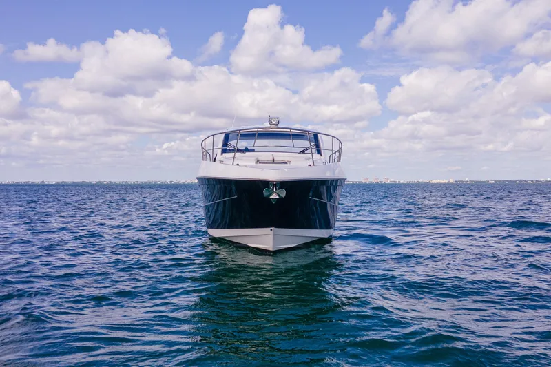 Slide: The Image of 2018 Cruisers Yachts 390 Express Coupe on open water under cloudy sky. - 7