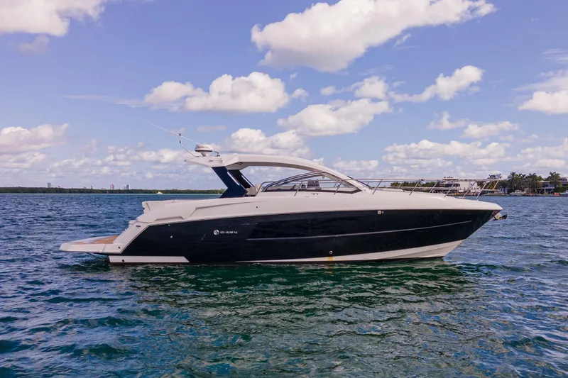 Slide: The Image of Aerial view of 2018 Cruisers Yachts 390 Express Coupe on vibrant green water. - 9