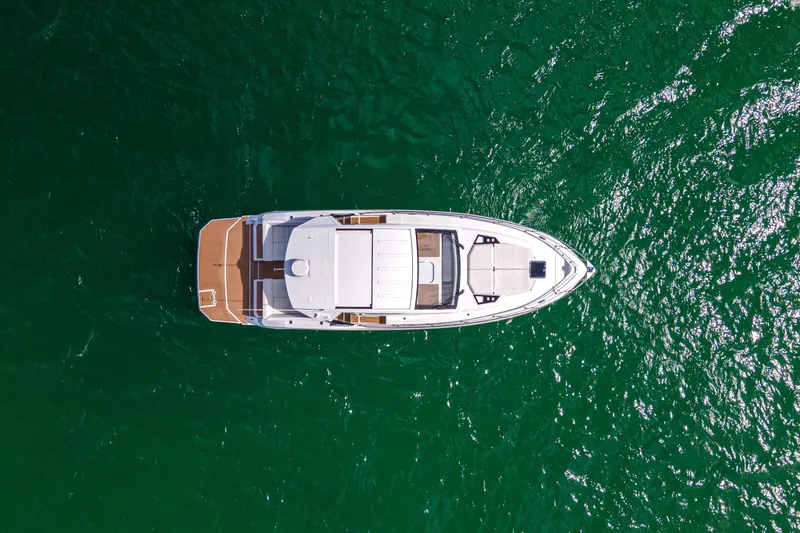 Slide: The Image of 2018 Cruisers Yachts 390 Express Coupe on open water, aerial view. - 10