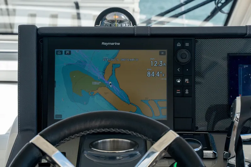 Slide: The Image of Control panel of 2018 Cruisers Yachts 390 Express Coupe with navigation screens and steering wheel. - 25