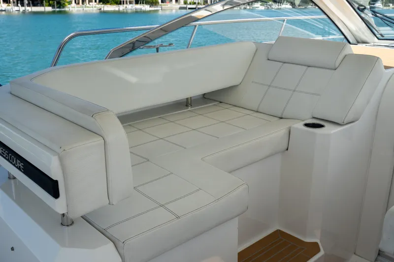 Slide: The Image of 2018 Cruisers Yachts 390 Express Coupe helm with luxurious seating and modern controls. - 29