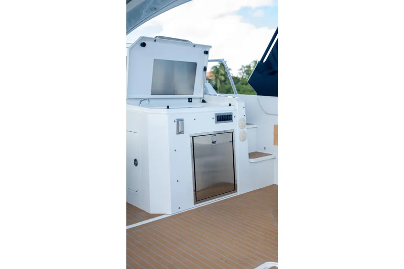 Slide: The Image of 2018 Cruisers Yachts 390 Express Coupe outdoor kitchen with grill and sink. - 33