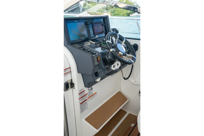 Slide: The Image of 2018 Cruisers Yachts 390 Express Coupe with sunbathing deck, docked by the water. - 42