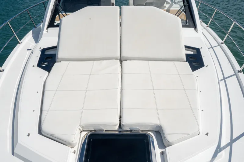 Slide: The Image of 2018 Cruisers Yachts 390 Express Coupe deck with seating and table, overlooking serene water. - 44
