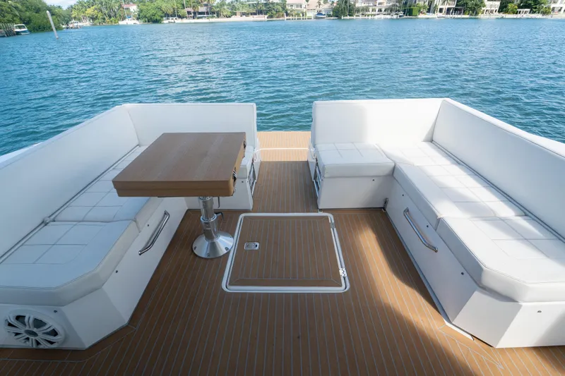 Slide: The Image of 2018 Cruisers Yachts 390 Express Coupe bow view on water, featuring sunpad and railing. - 45