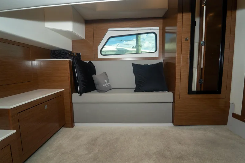 Slide: The Image of Luxurious cabin interior of 2018 Cruisers Yachts 390 Express Coupe with cozy bed and wooden cabinetry. - 64