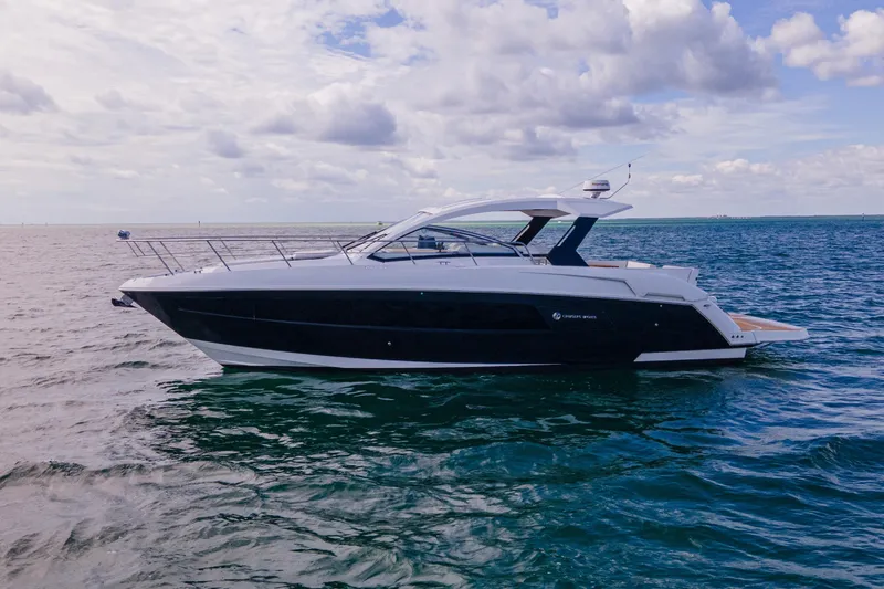 Slide: The Image of 2018 Cruisers Yachts 390 Express Coupe on open water under blue sky. - 8