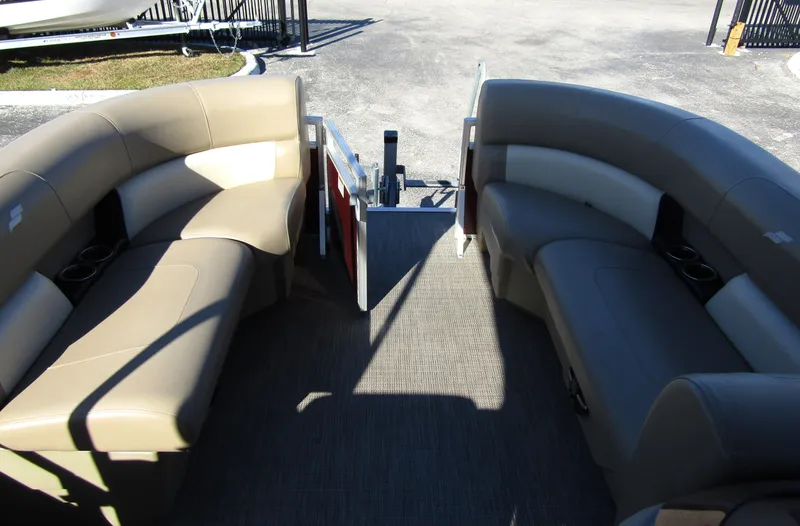 Slide: The Image of 2024 Starcraft LX 20 R pontoon boat interior with beige seating and open deck. - 7