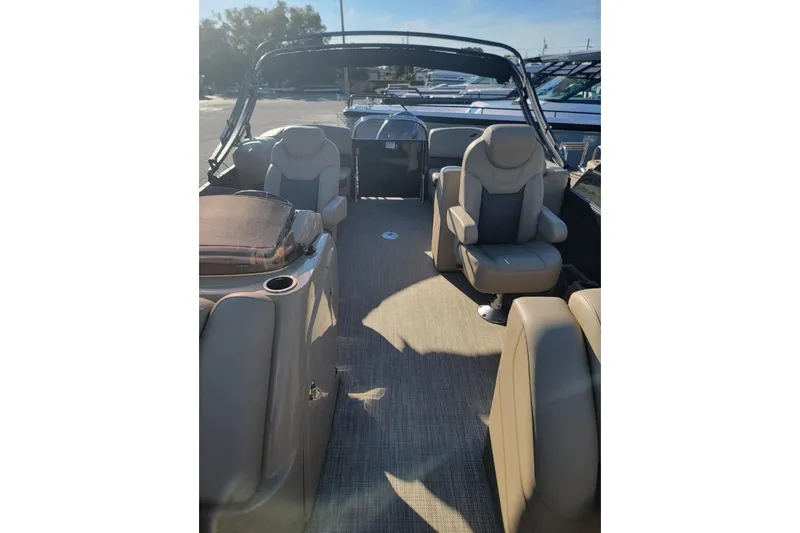 Slide: The Image of 2024 Starcraft SLS 1 boat interior with beige seating and open deck layout. - 2