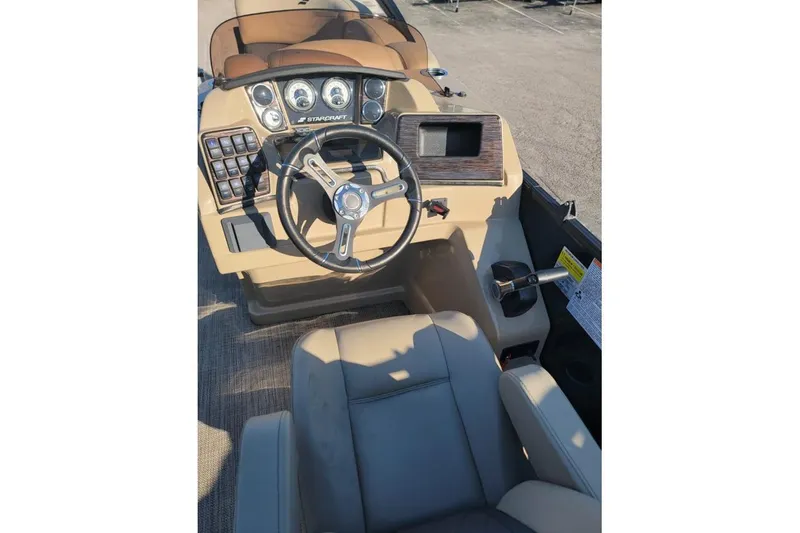 Slide: The Image of 2024 Starcraft SLS 1 boat dashboard with steering wheel and control panel. - 4
