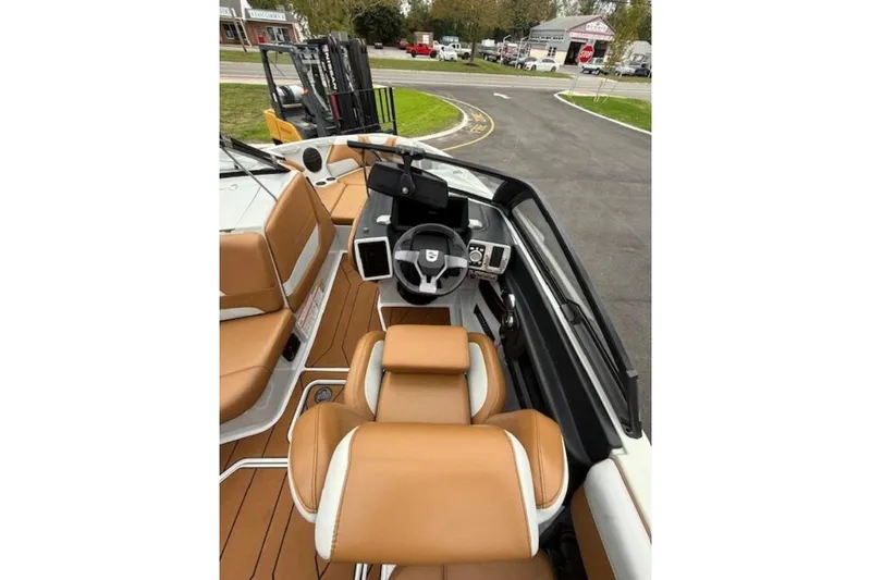 Slide: The Image of 2022 Malibu Wakesetter 22 LSV interior with tan seats and modern dashboard. - 6