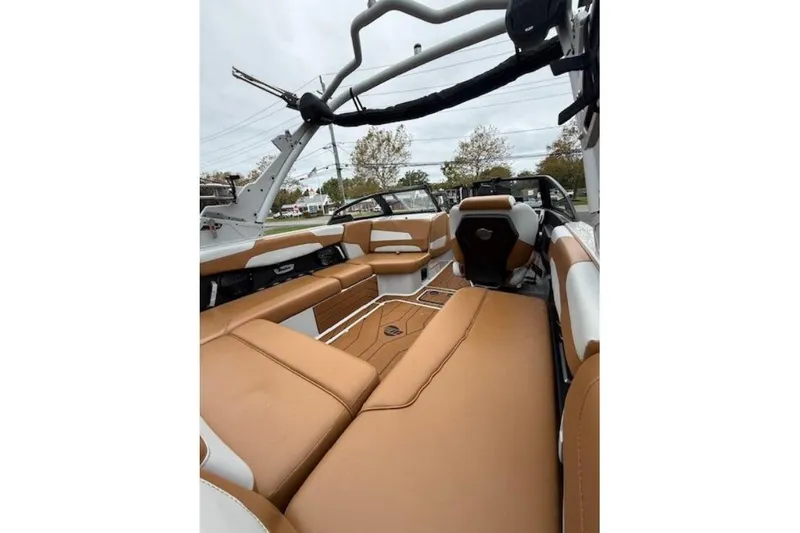 Slide: The Image of 2022 Malibu Wakesetter 22 LSV interior with tan and white seating, sleek design. - 7
