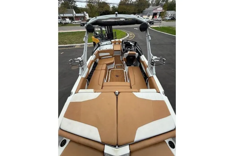 Slide: The Image of 2022 Malibu Wakesetter 22 LSV boat interior with tan and white seating. - 9