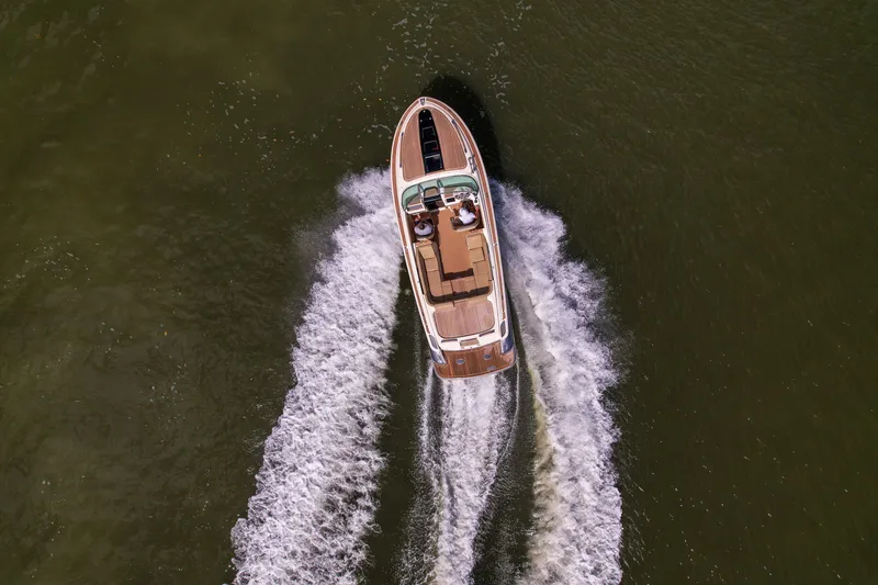 Slide: The Image of 2017 Chris-Craft Corsair 28 Heritage Edition cruising on open water, aerial view. - 10