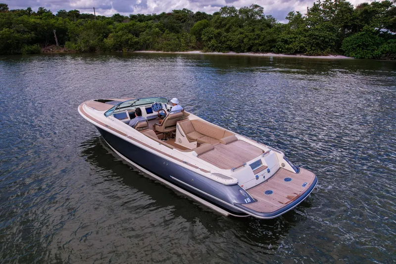 Slide: The Image of 2017 Chris-Craft Corsair 28 Heritage Edition boat cruising on a serene lake. - 11