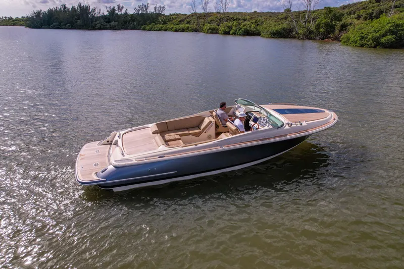 Slide: The Image of 2017 Chris-Craft Corsair 28 Heritage Edition boat cruising on calm water. - 2