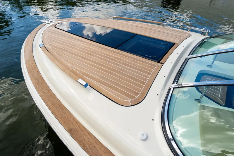 Slide: The Image of 2017 Chris-Craft Corsair 28 Heritage Edition boat with elegant teak deck on water. - 24